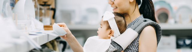 Woman shopping for dishes with her baby